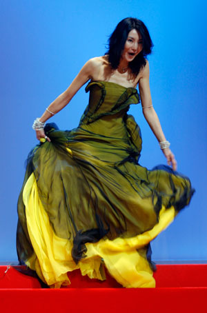 Jury member actress Maggie Cheung almost falls as she arrives on stage for the opening ceremony of the 60th Cannes Film Festival May 16, 2007.